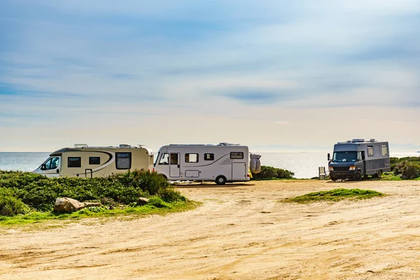 Caravans wild camping on mediterranean coast in Spain. Vacation in mobile home.