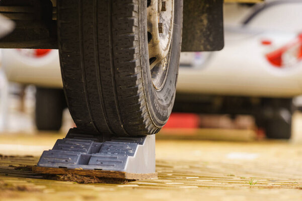 Caravan leveling block in use. Leveler ramp chock blocks for rv travel trailer. Accessories for motorhome.