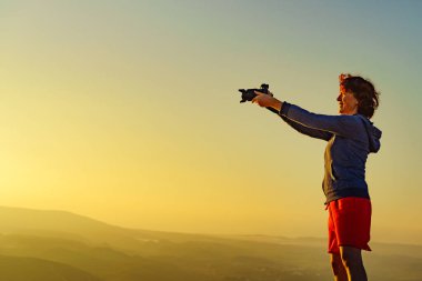 Kameralı turist kadın iyi bir bakış açısıyla seyahat fotoğrafı çekiyor.