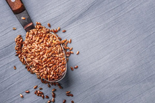 Flax seeds linseed on kitchen spoon — Stock Photo, Image