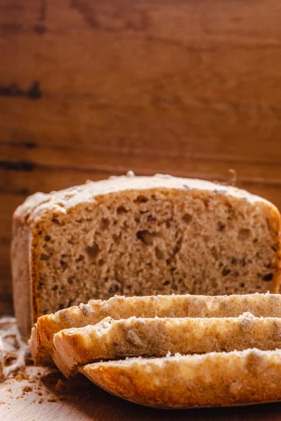 Kepekli ekmek kesme tahtası üzerinde dilimlenmiş — Stok fotoğraf