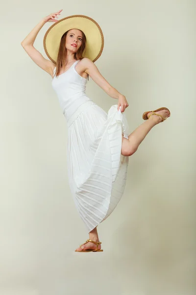 Woman in straw summer hat white dress jumping — Stock Photo, Image