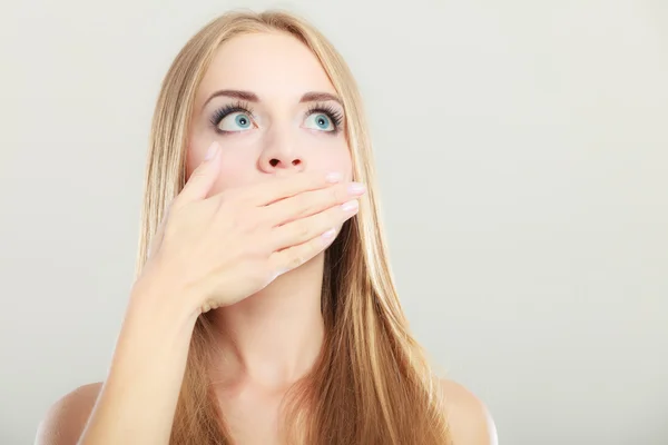 Amazed woman covering her mouth with hand — Stock Photo, Image