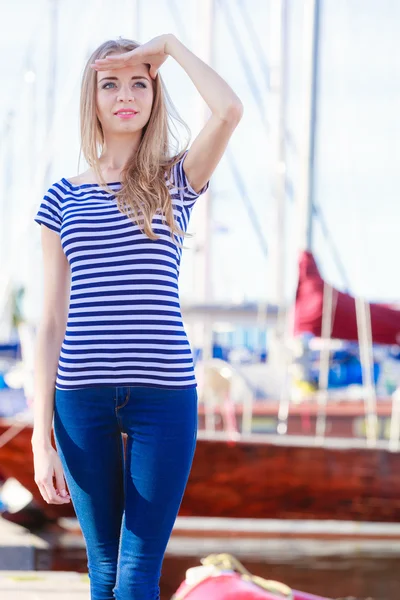 Vrouw in marina tegen jachten in de haven — Stockfoto