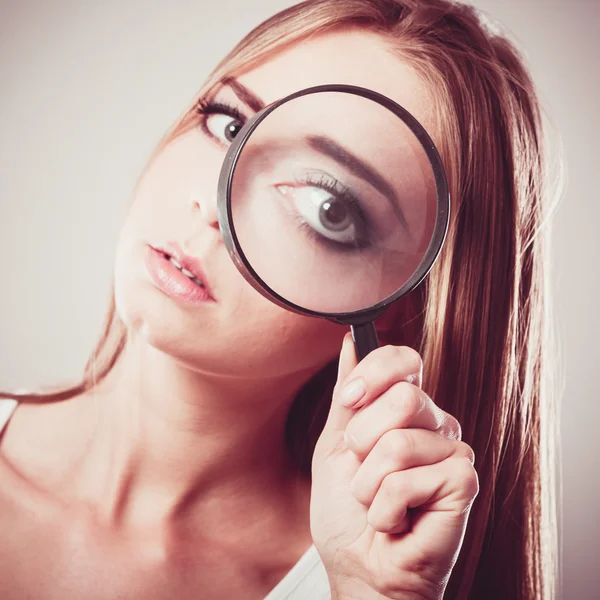 Girl holding on eye magnifying glass — Stock Photo, Image