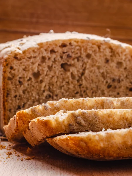 Kepekli ekmek kesme tahtası üzerinde dilimlenmiş — Stok fotoğraf