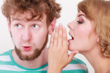 Woman telling an astonished man some secrets clipart