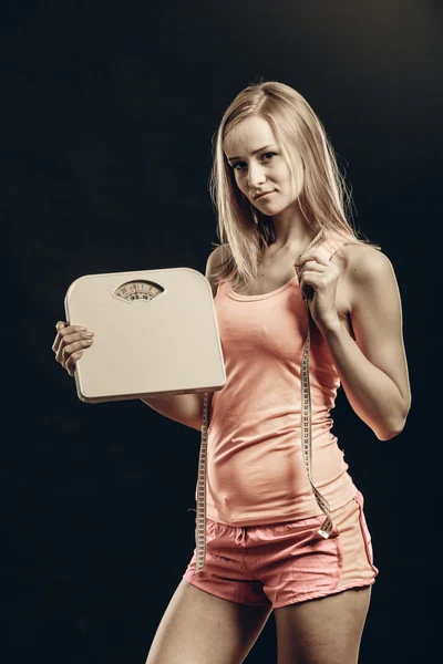 Woman with measure tape and scales — Stock Photo, Image