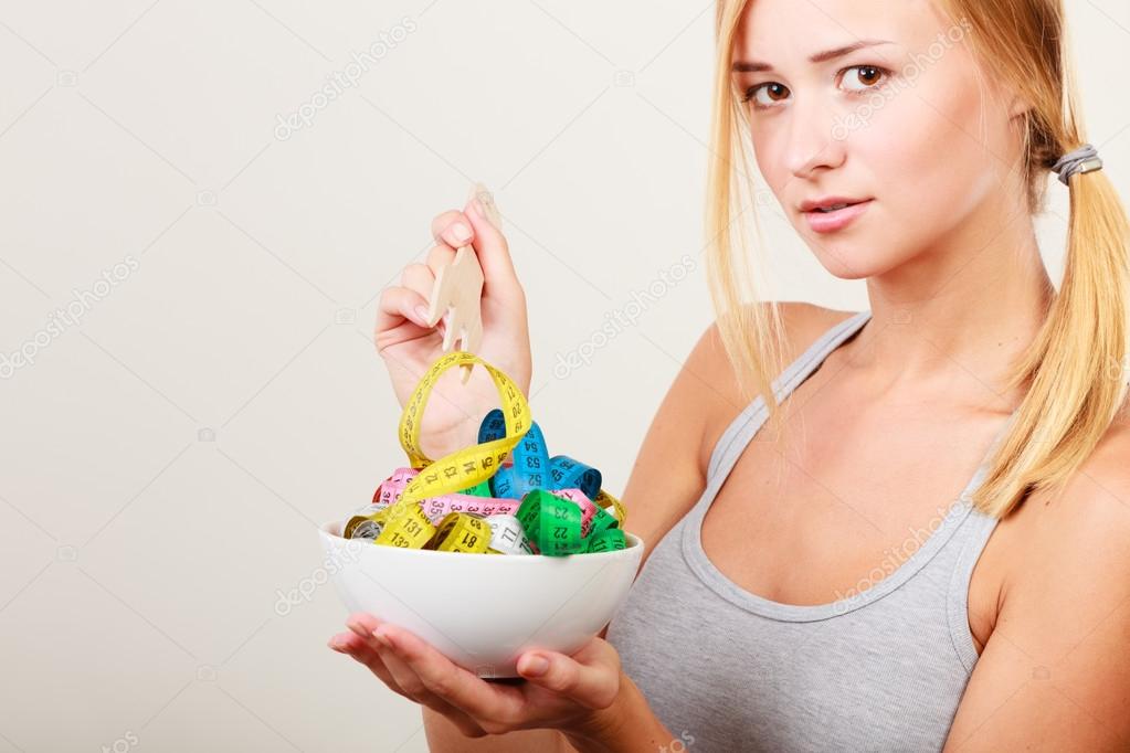 Girl holding bowl with measuring tapes