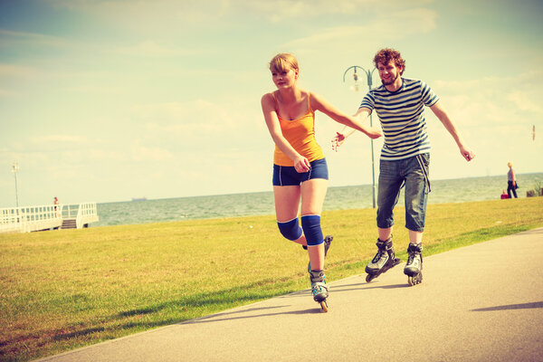 Young fit couple on roller skates