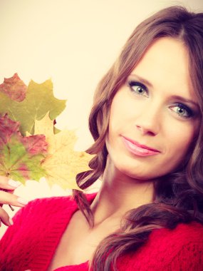 Pretty autumnal girl with maple leaves