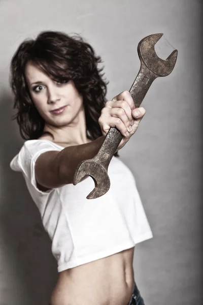 Sexy girl holding spanner tool — Stockfoto