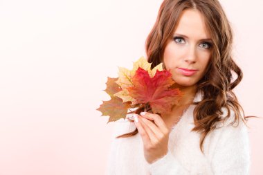 Pretty autumnal girl with maple leaves