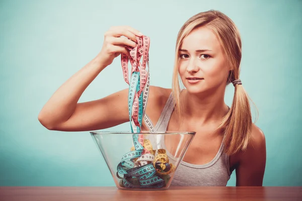 Diet. Girl with colorful measuring tapes in bowl — Stock Photo, Image