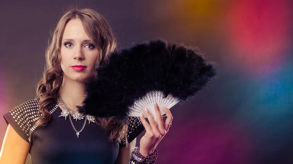 Beautiful brunette woman with black fan in hand — Stock Photo, Image