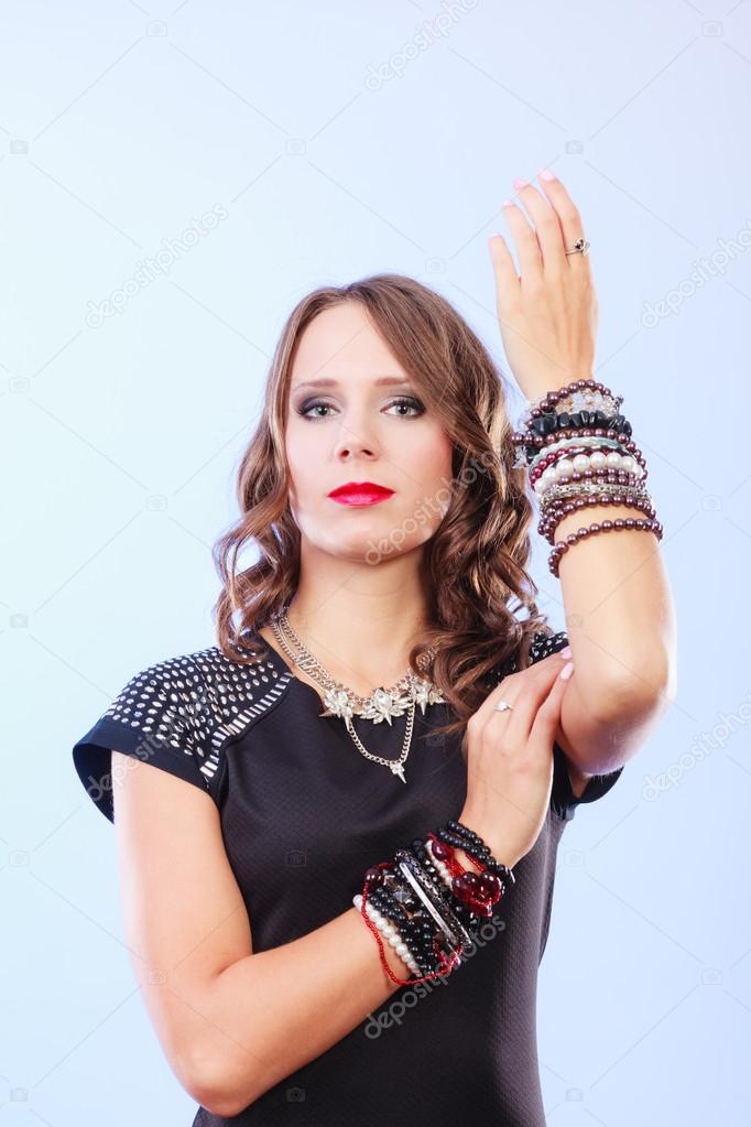 woman with jewellery in black evening dress