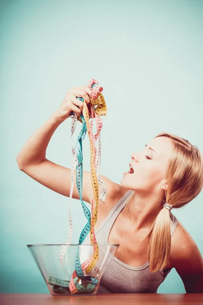 Diet. Girl with colorful measuring tapes in bowl — Stock Photo, Image