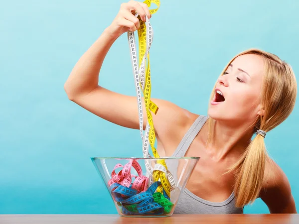 Diet. Girl with colorful measuring tapes in bowl — Stock Photo, Image