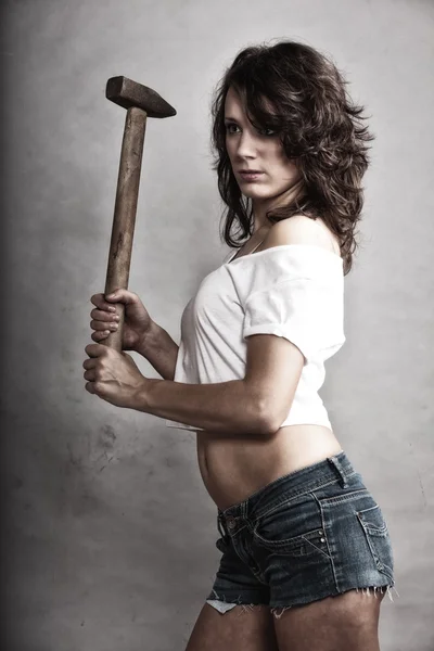 Sexy girl repairman holding hammer tool — Stock Photo, Image