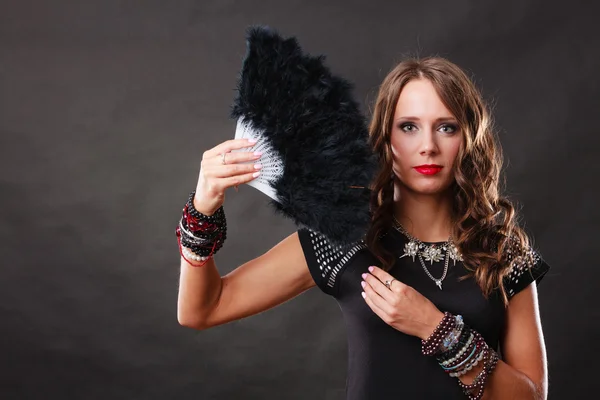 Beautiful brunette woman with black fan in hand — Stock Photo, Image