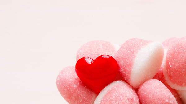 Pink jellies or marshmallows with sugar closeup