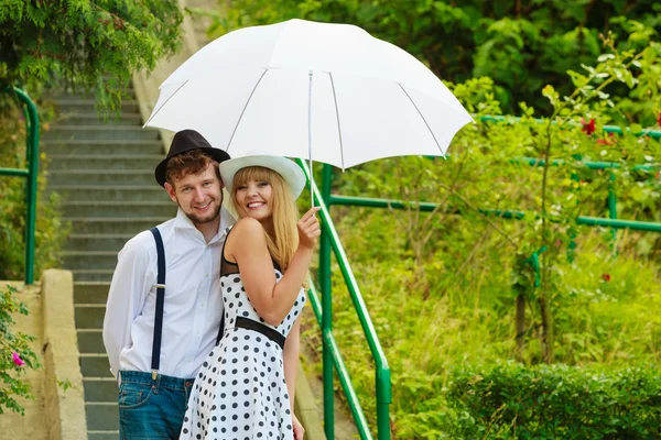 Loving couple retro style flirting on stairs — Stock Photo, Image