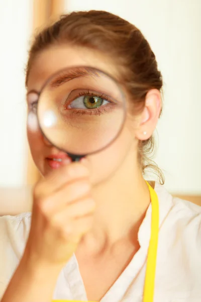 Kvinnan tittar genom förstoringsglas. — Stockfoto