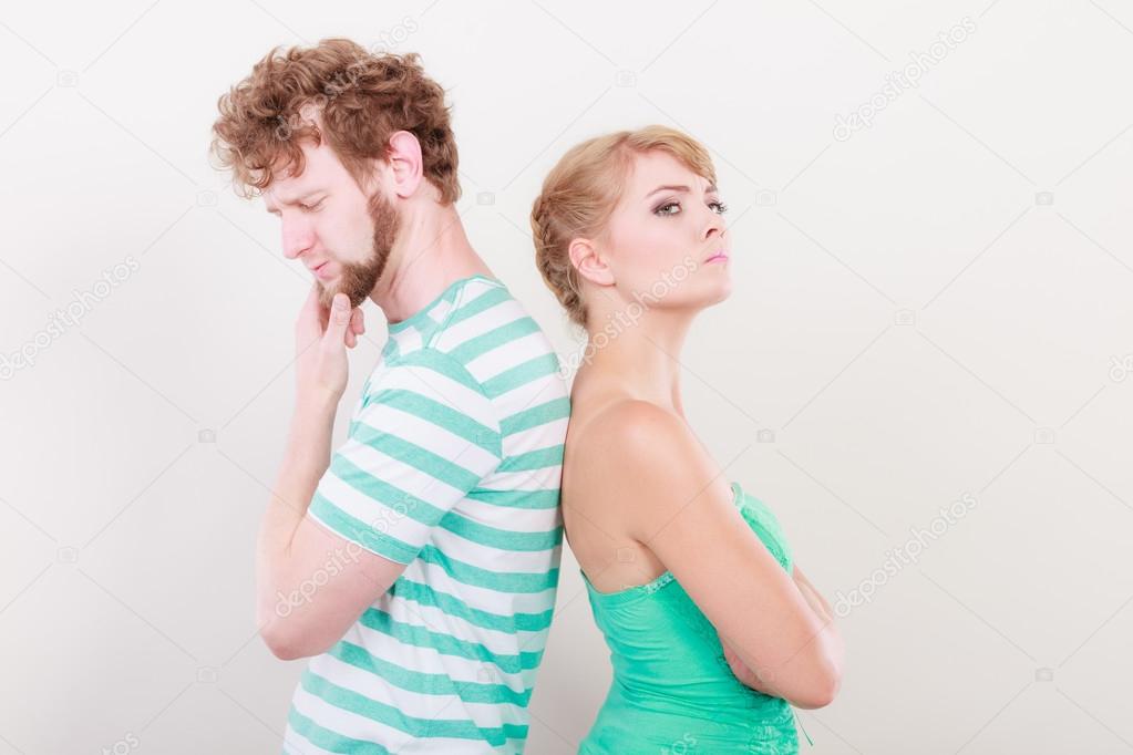 Young couple after quarrel offended back to back