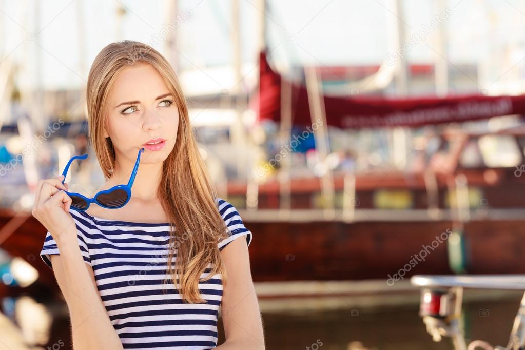 woman in marina against yachts in port