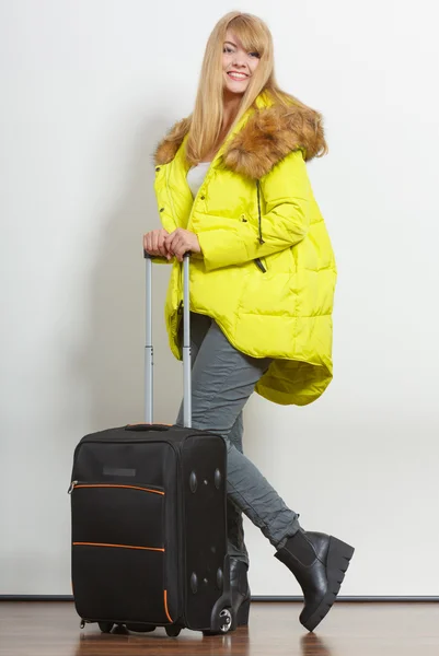 Happy young woman in warm jacket with suitcase. — Stock Photo, Image