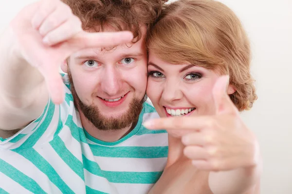 Feliz pareja haciendo marco con las manos —  Fotos de Stock