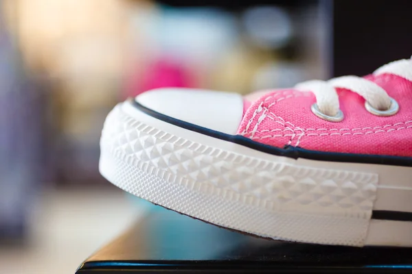 Closeup pink fashionable sneakers on shop shelf Royalty Free Stock Images