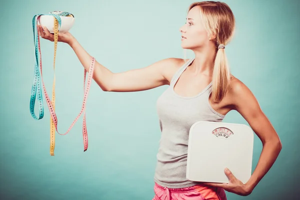 Girl with scales measuring tapes. Weight loss. — Stock Photo, Image