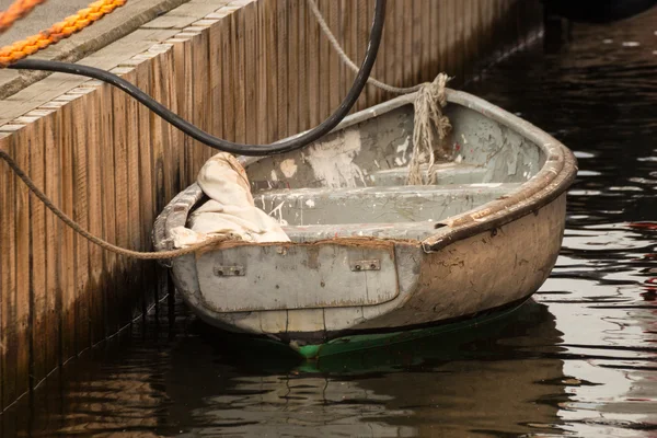 Old boat in harbor on pier — Stock Photo, Image