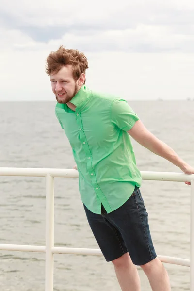 Young hipster man on sea pier — Stock Photo, Image