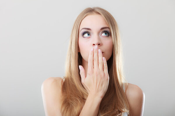 Amazed woman covering her mouth with hand