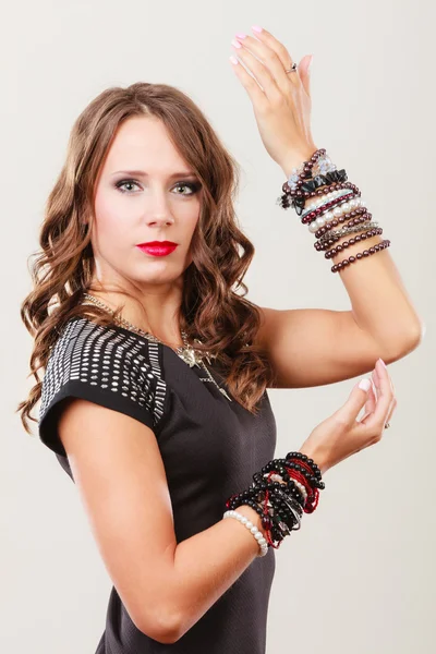 Woman with jewellery in black evening dress — Stock Photo, Image