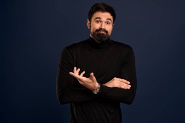 Guy arguing with coworker, having intense discussion, complaining on something, raise one hand in dismay, staring camera perplexed or puzled, asking question, talking over Pacific Blue background.