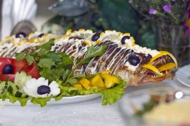 Pişmiş balık ve güzel süslenmiş festival masası.