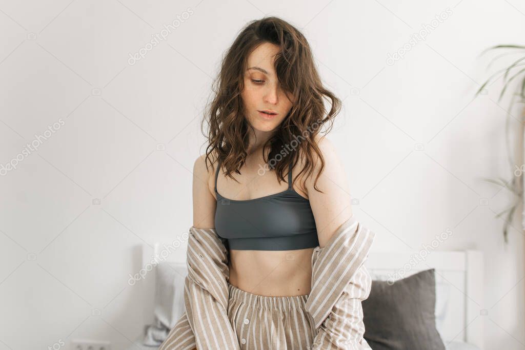 morning of a young woman in comfortable linen pajamas