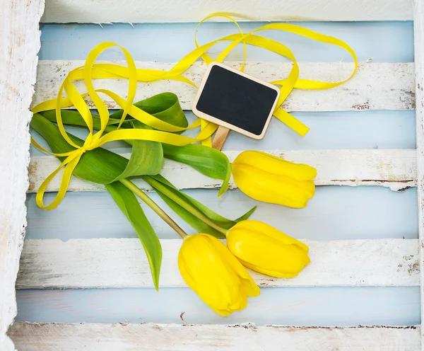 Frische gelbe Tulpen mit Band. — Stockfoto