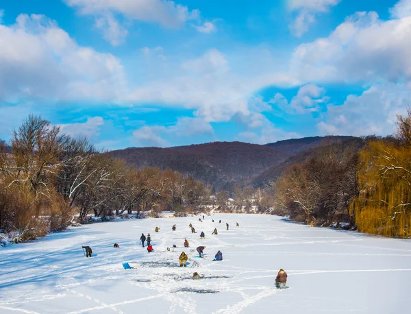 Ice fishing on a frozen river — Stock Photo, Image
