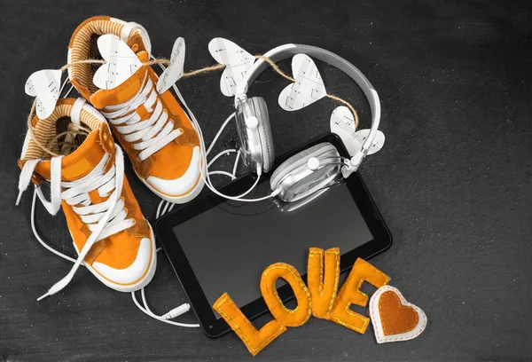 Love for music concept.Orange sneakers, headphones, tablet and h — Stock Photo, Image