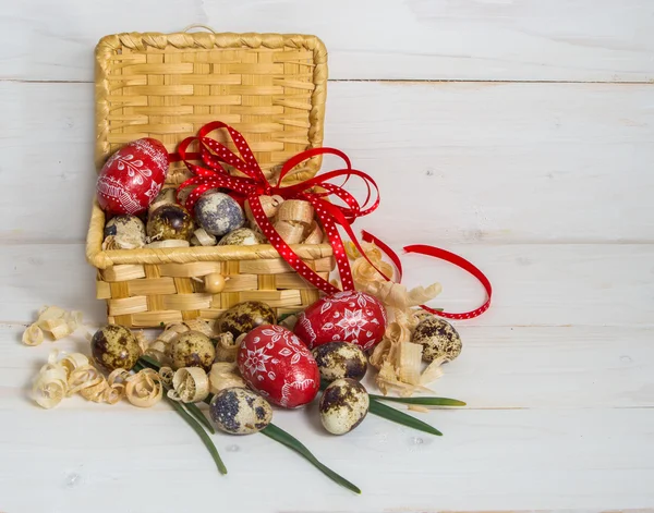 Huevos de Pascua en una cesta decorada con un lazo rojo. Víspera de Pascua — Foto de Stock