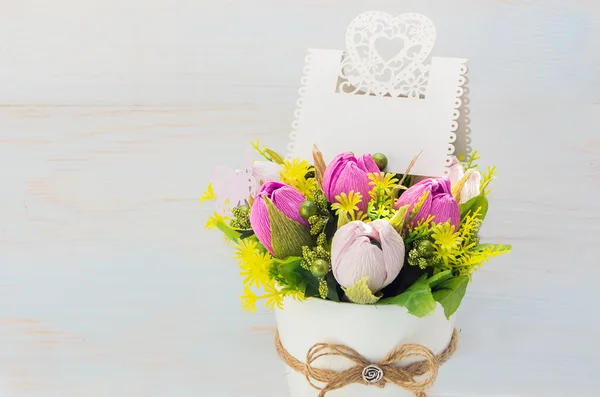 Decorative flower in a pot and gift with a card — Stock Photo, Image