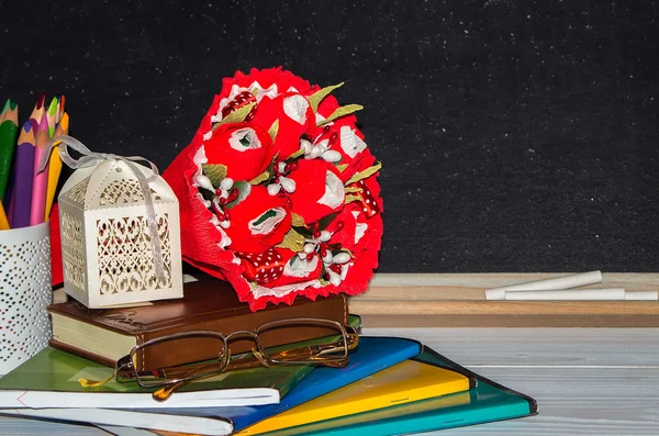 Flores y regalos, copybooks en el escritorio del profesor . . — Foto de Stock