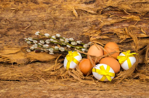 Ovos de Páscoa cor branca e marrom com fitas amarelas — Fotografia de Stock