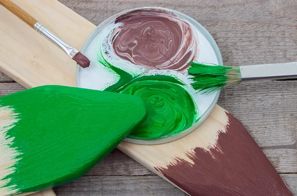 Paintbrush and green, brown paint — Stock Photo, Image