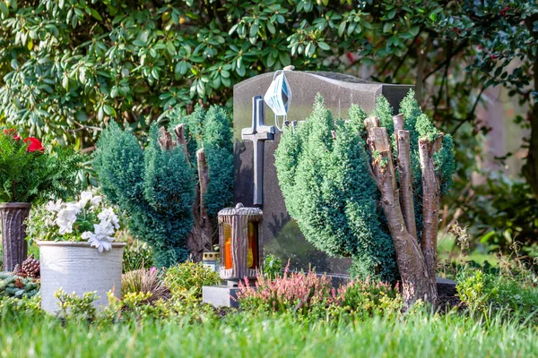 Facemask lying on grave of family members with a facemask during the pandemic — Stock Photo, Image