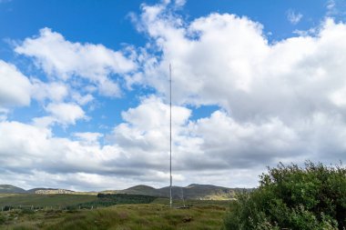 Glenties in County Donegal 'in İrlanda dağlık arazisindeki bir tarımsal alanda bulunan bir vericinin sokak görüntüsü